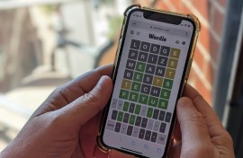 This photo illustration shows a person playing online word game Wordle on a mobile phone