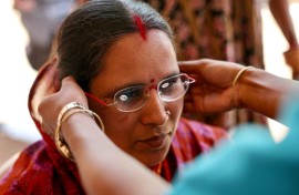 Weaver Savita Maharana tries on spectacles at GoodVision India – Care Netram charity's eye screening camp in Cuttack's Maniabandha village
