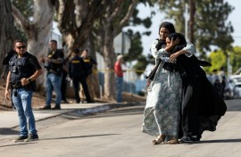 Two women react following a shooting at the Islamic Center of San Diego, in southern California, on May 18, 2026 that left three people dead