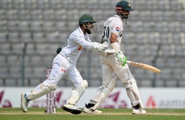 Bangladesh's Litton Das (L) celebrates after the dismissal of Pakistan captain Shan Masood (R)