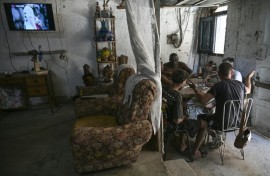 Havana residents play dominoes to pass the time amid frequent Cuban blackouts and the looming threat of US invasion
