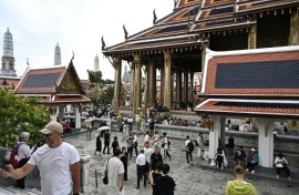 Visitors walking around the Grand Palace in Bangkok