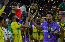 Keanu Cupido (L) and captain Ronwen Williams hold the CAF Champions League trophy after winning the final against FAR Rabat.
