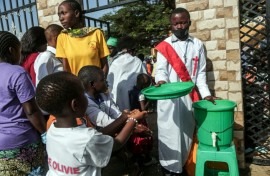 Parishioners wash their hands before entering church as their region battles an Ebola outbreak which has killed more than 200 people