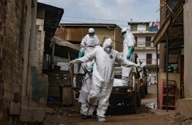 A Ugandan Red Cross worker during the evacuation of the body of a suspected Ebola victim in Kampala on May 26
