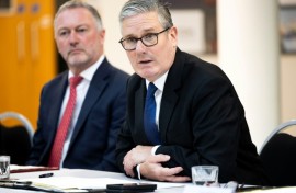 Britain's Prime Minister Keir Starmer (R) has clashed with Elon Musk previously
