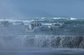 Stormy seas pound the coastline of Island Bay, a suburb of the New Zealand capital Wellington