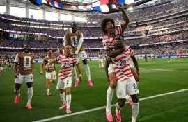 United States striker Folarin Balogun celebrates with team-mates after scoring in the World Cup co-hosts victory over Paraguay