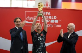 Canada's Prime Minister Mark Carney holds aloft the World Cup trophy next to FIFA President Gianni Infantino in May