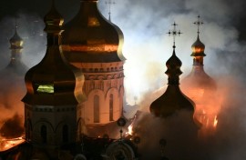 Smoke and fire rises from the Dormition Cathedral in the Orthodox in Kyiv