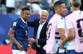 France coach Didier Deschamps congratulates Kylian Mbappe, who scored twice in his team's 3-1 win over Senegal on Tuesday at the World Cup