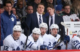 Jim Hiller, left center standing, was named the new head coach of the NHL Toronto Maple Leafs by the club, for which he was formerly an assistant coach