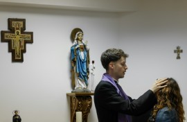 Self-proclaimed priest Francisco Marques lays his hands on a woman during an exorcism retreat in Portugal