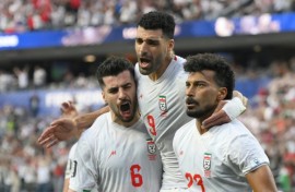 Iran players celebrate after scoring during their first World Cup match, a 2-2 draw against New Zealand in Los Angeles