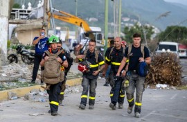 First responders from France walk along a street in hard-hit La Guaira state