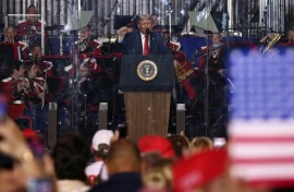 US President Donald Trump raises a fist as he speaks during the kick-off celebration for the "Great American State Fair" on the National Mall in Washington, DC, to celebrate the 250th anniversary of US independence