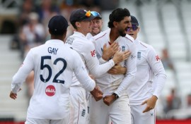 England off-spinner Shoaib Bashir (2R) celebrates with teammates after trapping New Zealand's Rachin Ravindra lbw in the third Test at Trent Bridge