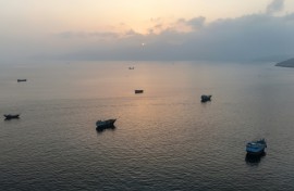 This aerial photograph shows boats anchored off Oman's northern Musandam Peninsula near the Strait of Hormuz on June 27, 2026