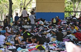 People sift through clothing at a donation center in Caraballeda, La Guaira state