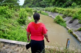Eva Sevillano, a resident of the Nueva Prosperina neighborhood of Ecuador's port Guayaquil, stands at the waterway known as the Canal de la Muerte (Death Canal)