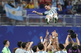 Argentina forward Lionel Messi is tossed into the air by team-mates after inspiring a late fightback in a 3-2 victory over Egypt