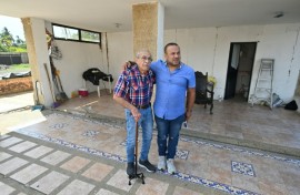 Engineer Elias Chayeb (L) and his son, engineer Elias Eduardo Chayeb, were relieved upon seeing a small residential building they helped build had withstood the two violent earthquakes in Venezuela