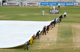 Ground staff pull on the covers during the fifth and final day of the second Test between Sri Lanka and West Indies