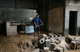 Residents of China's Liulan began the long process of cleaning up their wrecked homes after devastating storms
