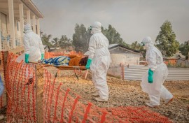 Healthcare workers carry a patient suffering from Ebola at a treatment centre in Bunia