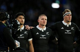 German-born Anton Segner (centre) sings the national anthem as he lines up with fellow All Blacks Wallace Sititi (left) and Sam Darry before the Nations Championship match against Italy in Wellington