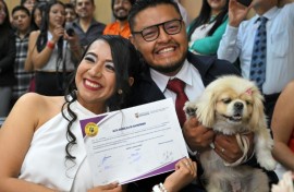 Diana Tupiza and Andres Alquinga pose with their dog Luna, who served as a "witness" at their civil wedding and stamped the marriage certificate with her paw print