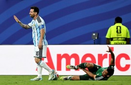 Argentina forward Lionel Messi gestures after fouling Algeria's Aissa Mandi, which pundits say should have earned him a red card