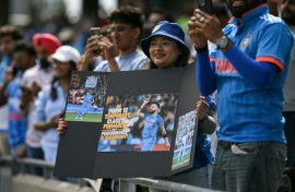 India fans watch as the team take to the field before the start of the first one-day international (ODI) cricket match against England at Edgbaston in Birmingham, central England