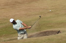 Scottie Scheffler plays from a bunker during practice for the British Open at Royal Birkdale