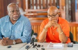 Guyana's Prime Minister Mark Phillips (L) and Minister of Public Works Juan Edghill (R) speak at a press conference after a ferry disaster