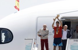 Spain's captain Rodri holds up the World Cup trophy after the team returned to Madrid