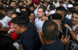 Security personnel detain Indian opposition leader Rahul Gandhi (C) during a protest outside Prime Minister Narendra Modi's residence in New Delhi on Tuesday
