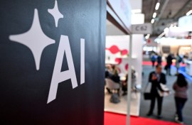 People walk past a banner for AI at the 2024 Frankfurt book fair