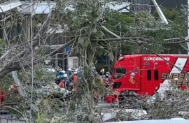 Rescue workers outside the damaged Aeon Mall Kumamoto shopping center in southwestern Japan following a major earthquake.