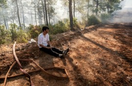 A volunteer rests amid operations to tackle a wildfire in Fethiye, southwest Turkey