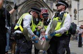 Police remove protesters from outside the Royal Courts Of Justice in central London in June