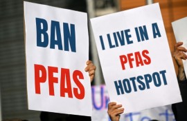 Environmental activists hold placards during a demonstration against PFAS chemicals next to the EU Commission headquarters in Brussels in March 2026