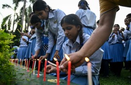 Mourners and students at Small Heaven School in Chitwan light candles after the death of mountaineer Nirmal Purja and his companions in an avalanche in Pakistan