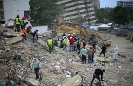 Rescue teams and volunteers search for bodies amid the rubble of a collapsed building in Caraballeda, Venezuela, on August 3, 2026