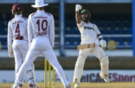 Pakistan batsman Abdullah Shafique (R) celebrates his century late on the second day against the West Indies