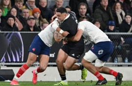 New Zealand hooker Codie Taylor (C) is tackled during a 2025 Test against France in Dunedin.