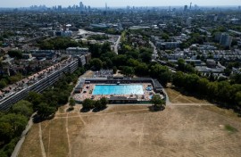 Swimmers use London's Parliament Hill Fields Lido, with the UK on course to record its warmest summer on record for the second year running