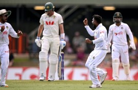 Bangladesh bowler Mehidy Hasan Miraz (2nd R) after dismissing Australia's batsman Pat Cummins in Darwin