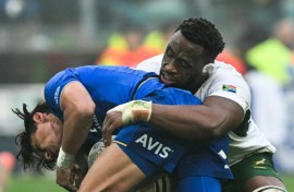 South Africa captain Siya Kolisi (R) makes a tackle during a tour victory over Italy last November.