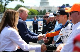 US President Donald Trump and First Lady Melania Trump, at left, greet IndyCar drivers before the start of the Freedom 250 Grand Prix on the streets of Washington
